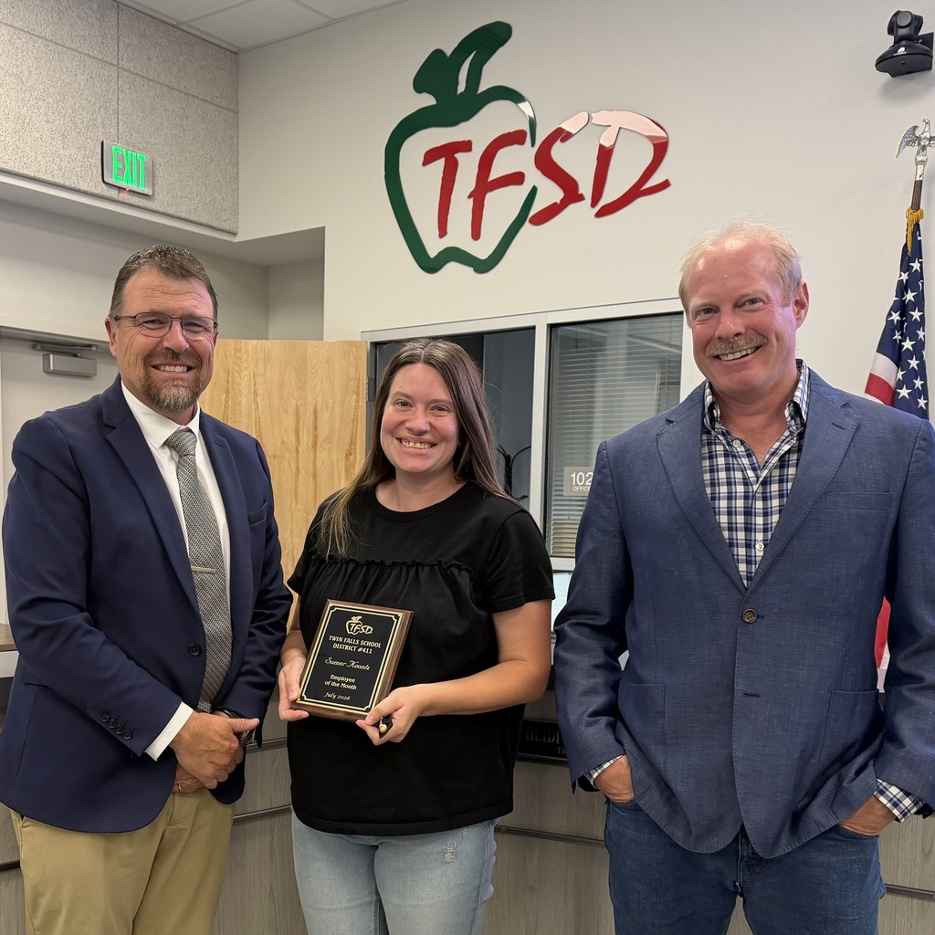 Employee of the Month pictured with superintendent and board member.