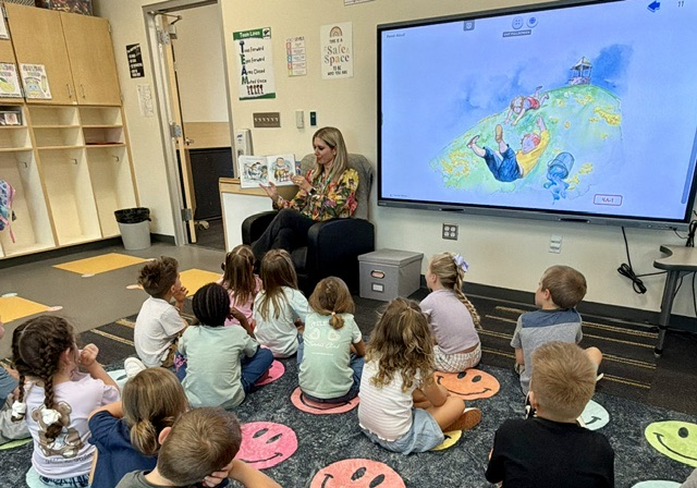 principal reading to kindergarten students