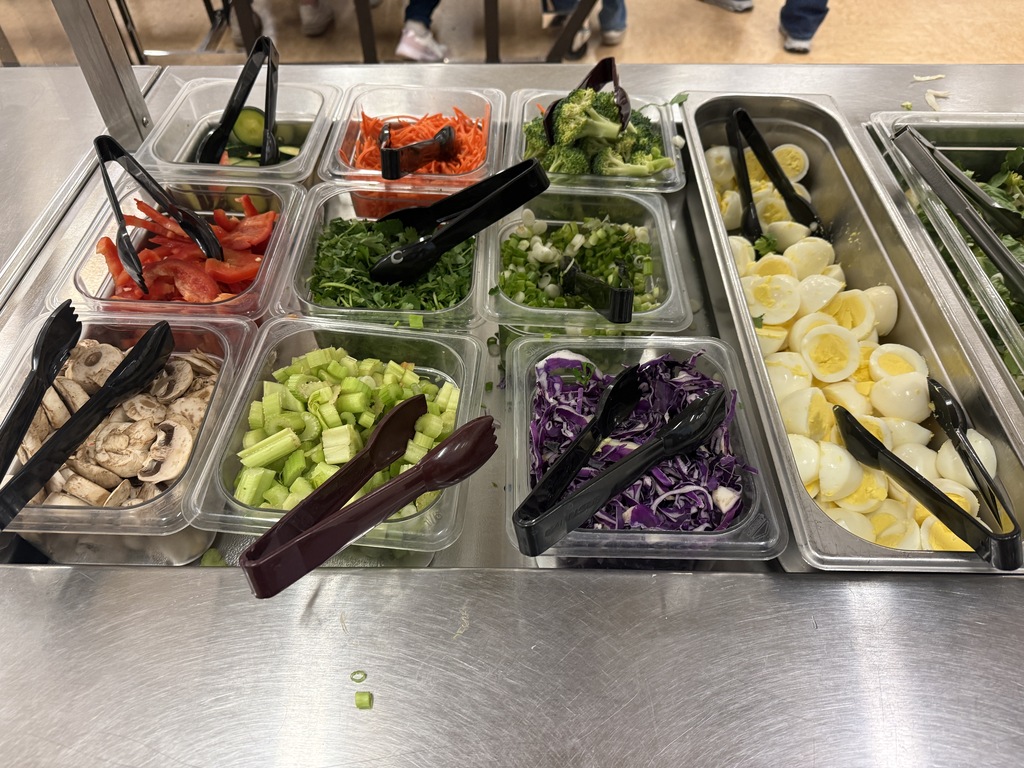 A picture of meat toppings for lu a variety of toppings on a food bar at lunch