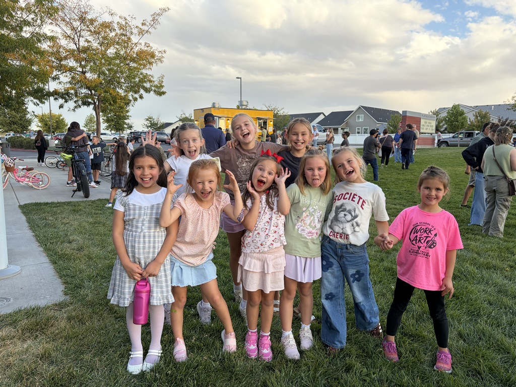 kids smiling on the grass