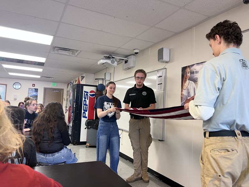 Military Leadership student practice folding the flag. 