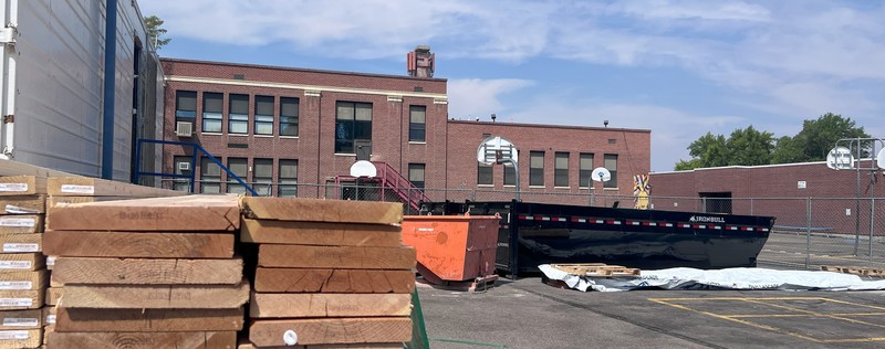 Lincoln Elementary School with stack of lumber .