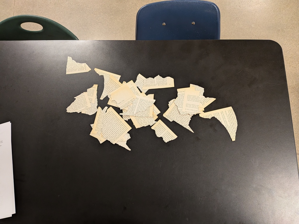 Torn pages of a book sitting on a table.