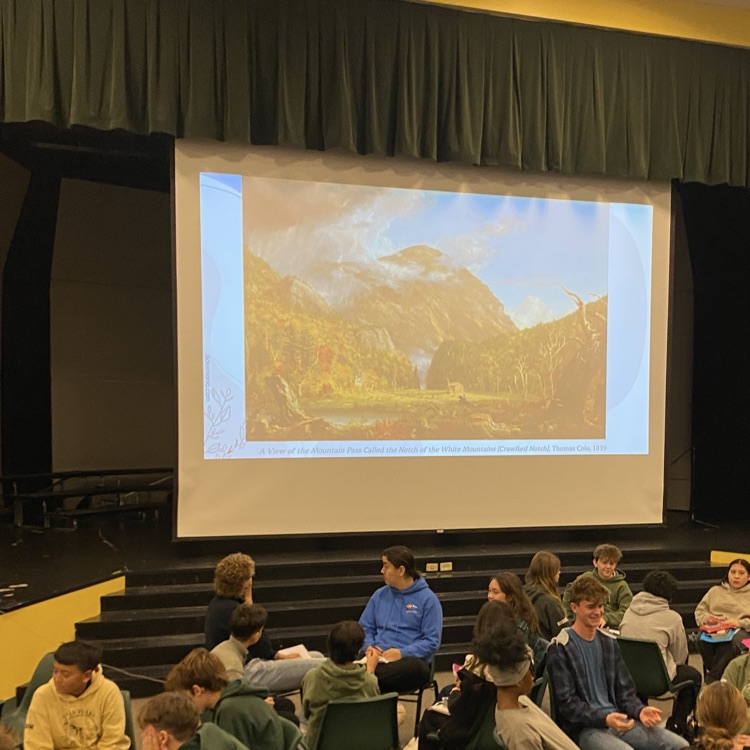 Students talking in the comments about what is home with a picture of a mountain on the projection