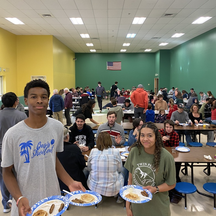 Basketball players serving breakfast to community