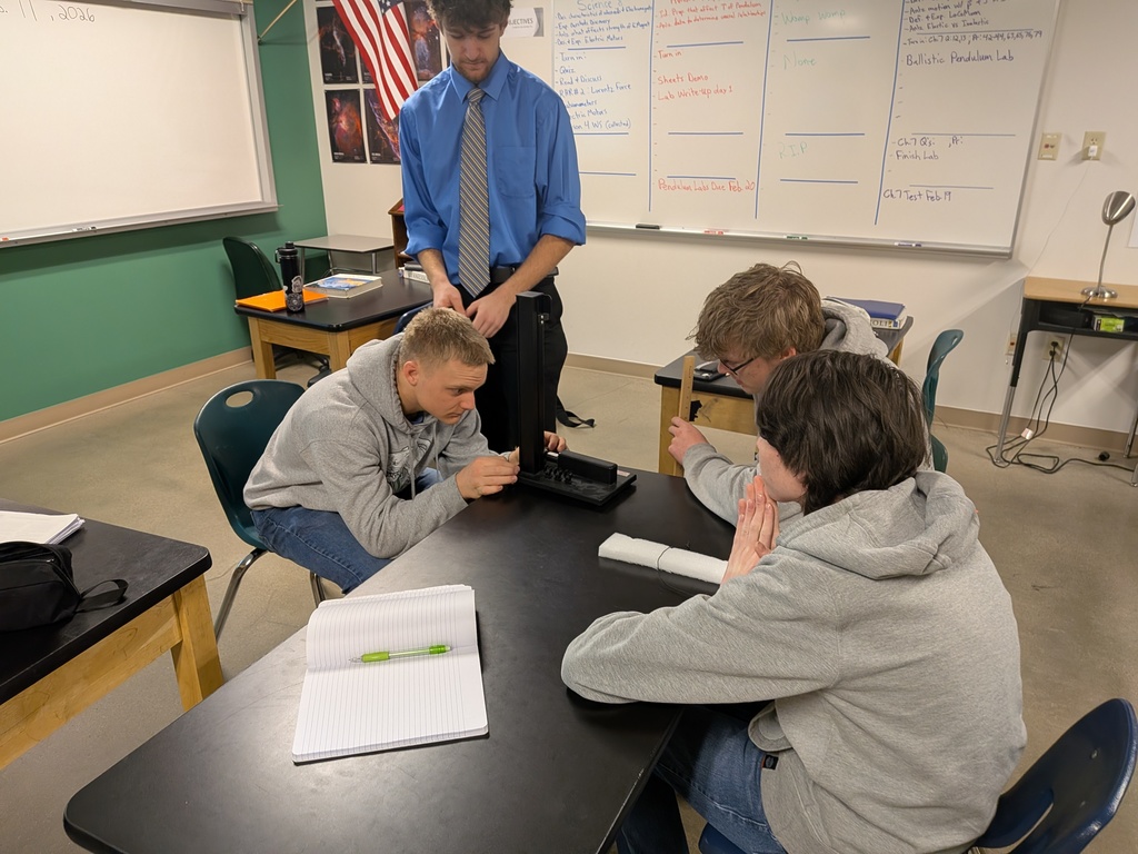 A student making adjustments to a pendulum
