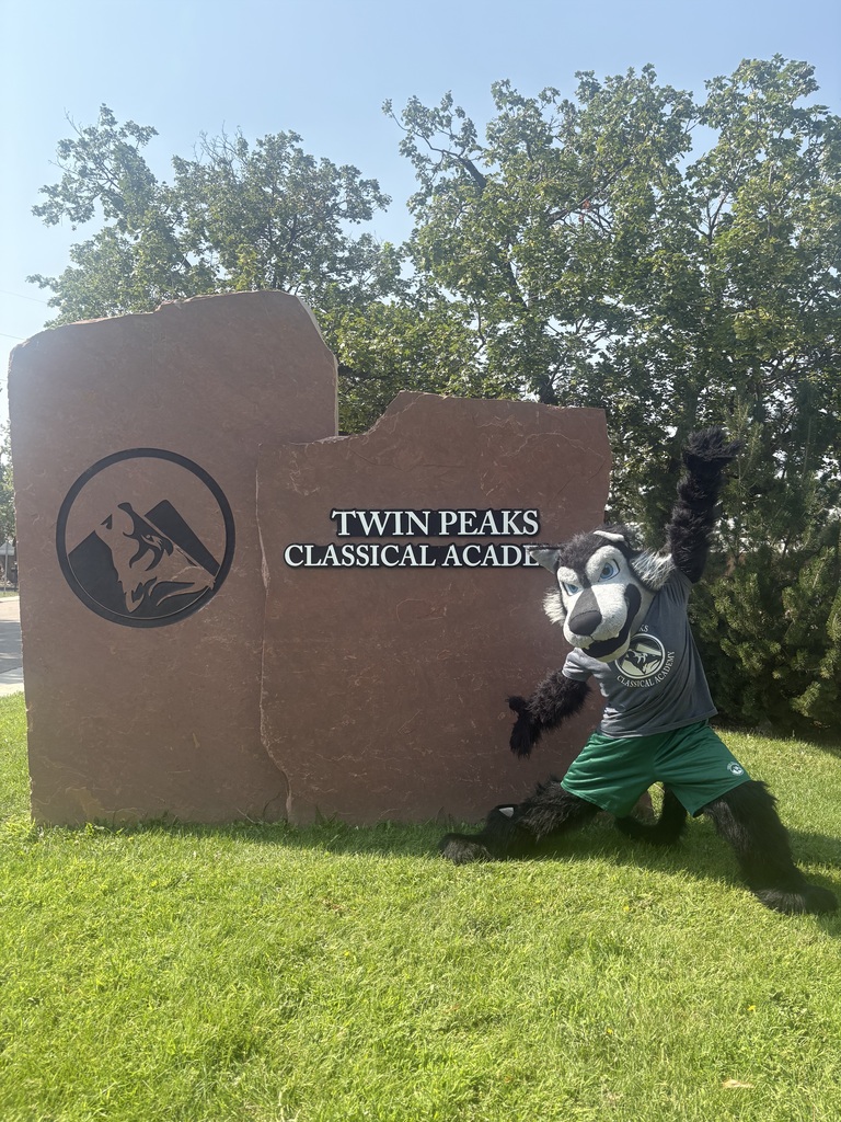 Fang next to Twin Peaks Classical Academy school sign