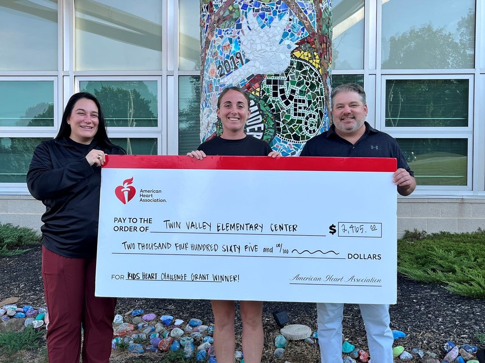 holding a large grant check