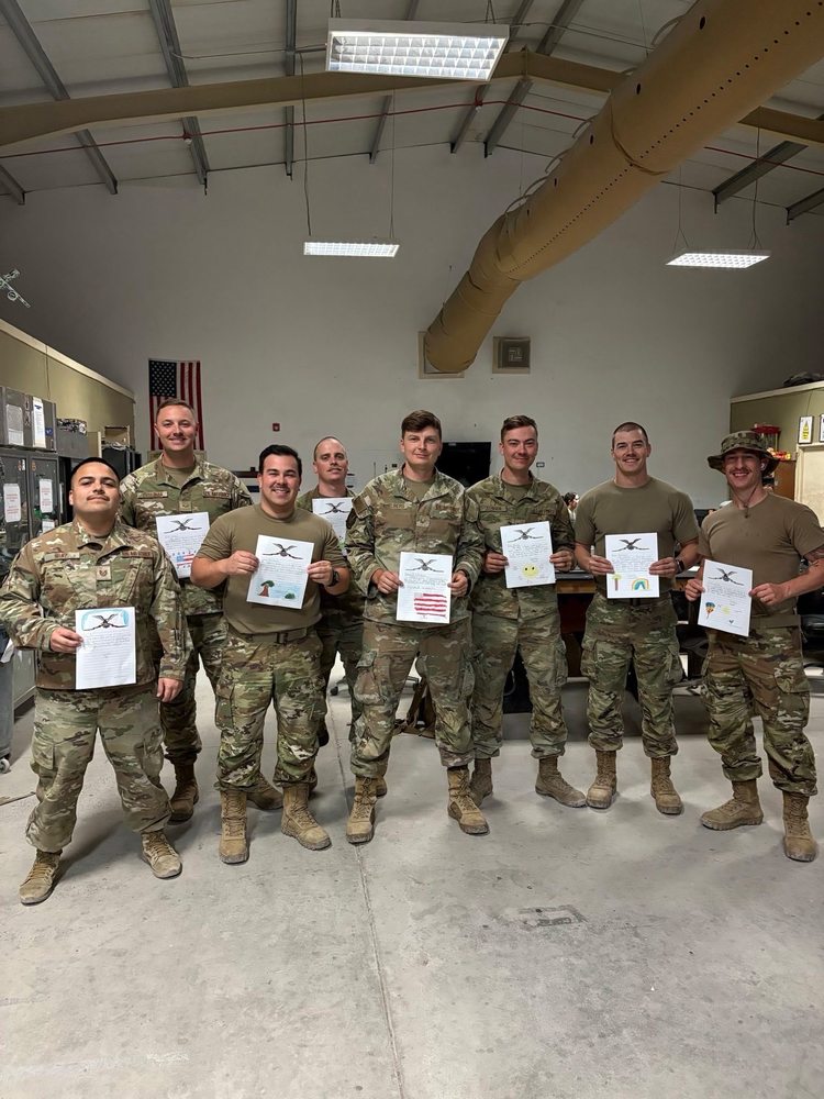 soldiers holding up student letters