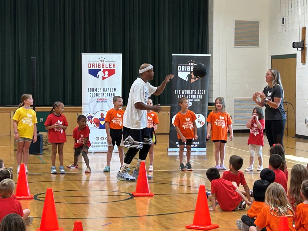 Corey The Dribbler playing a game with students and a teacher