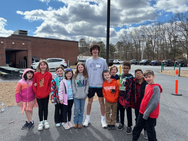 high school student with group of young students