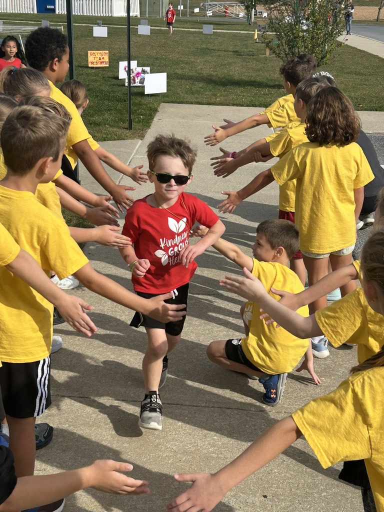 student running with students high-fiving from the sidelines