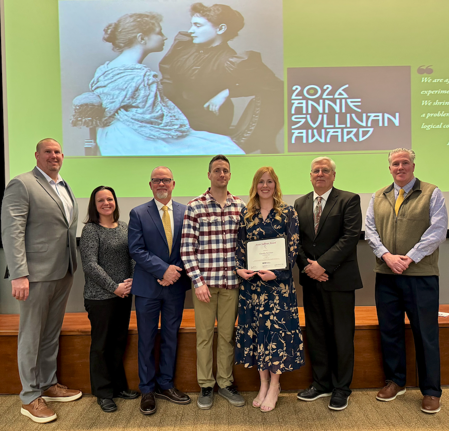 claudia sweitzer smiling and holding award alongside TVSD peers