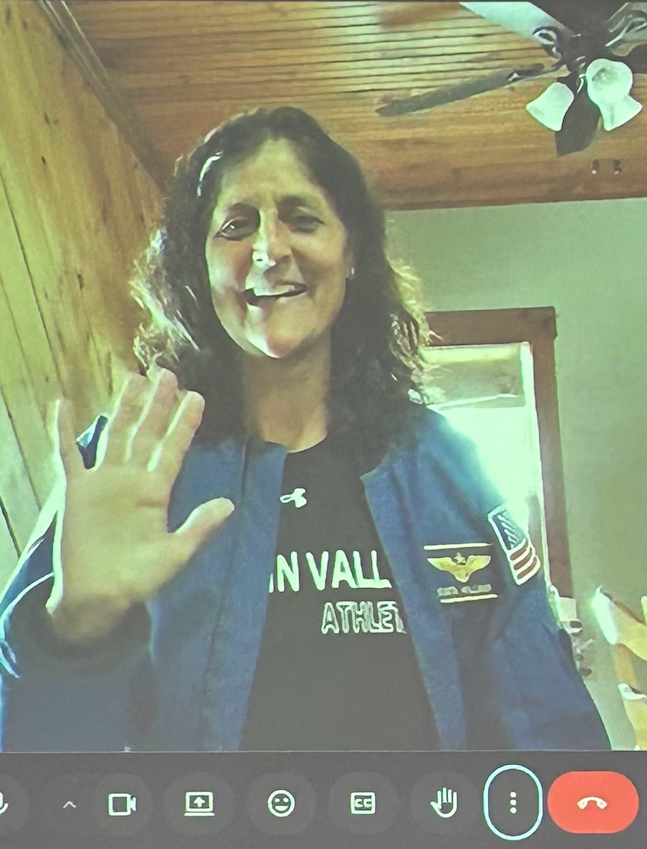 Sunita Williams waving to students from a Zoom screen