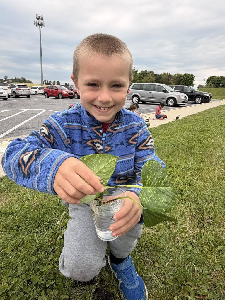 student smiling with plant