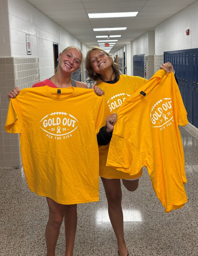 Two high school students holding Gold Out t-shirts for Mini THON