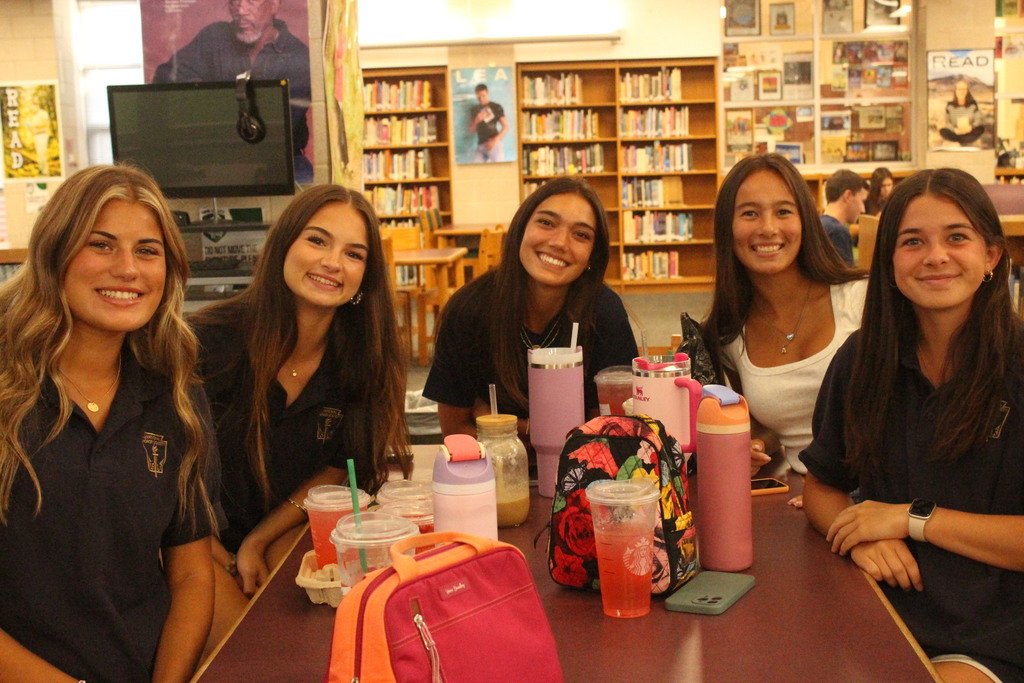 student smiling at table