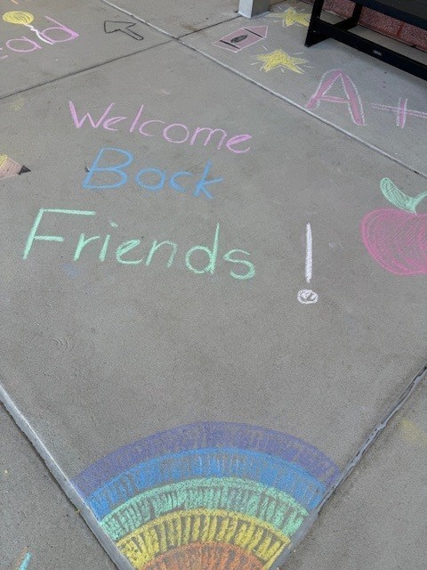 Chalk on sidewalk- Welcome back friends
