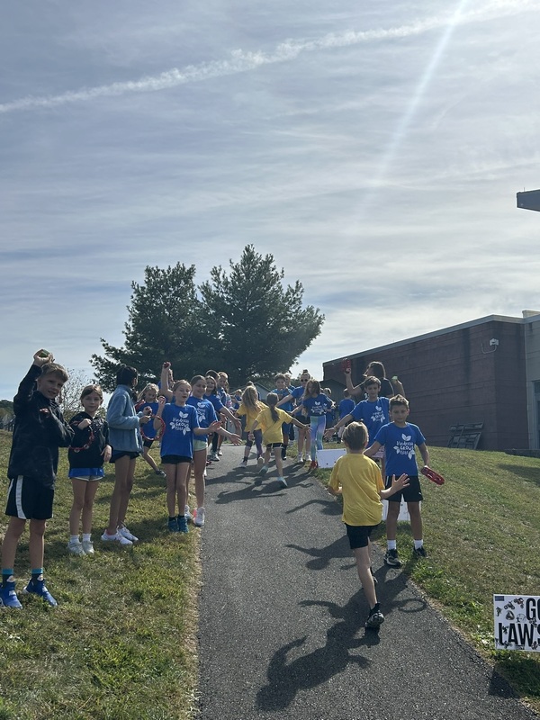 Students running and high fiving