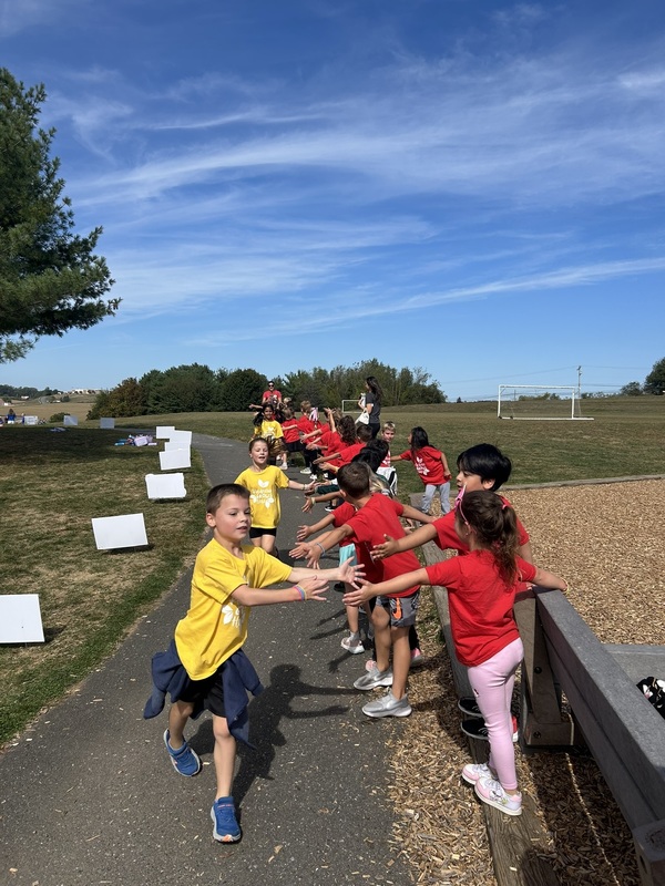 Students running and high fiving