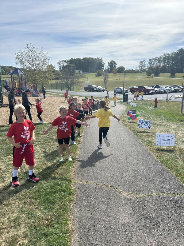 Students running and high fiving
