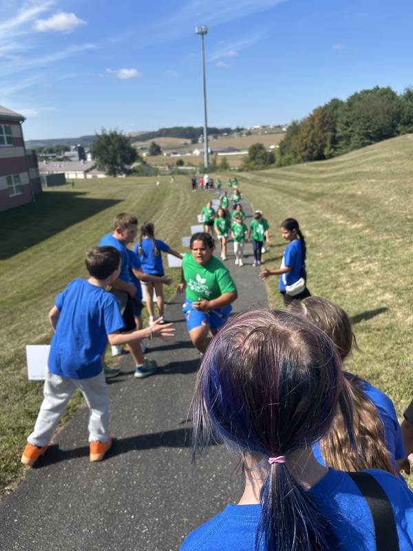 Students running and high fiving