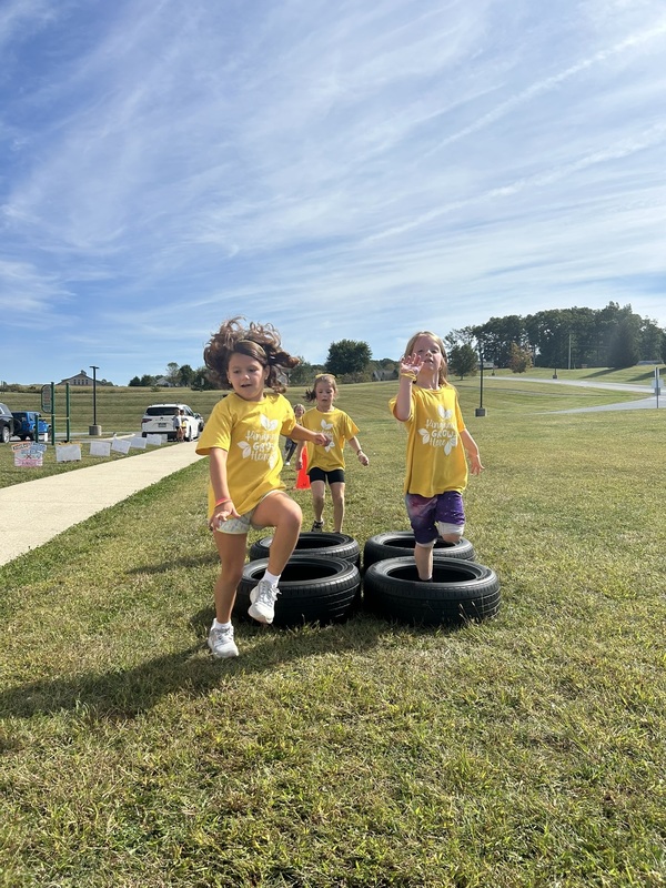 students going through tire obstacle