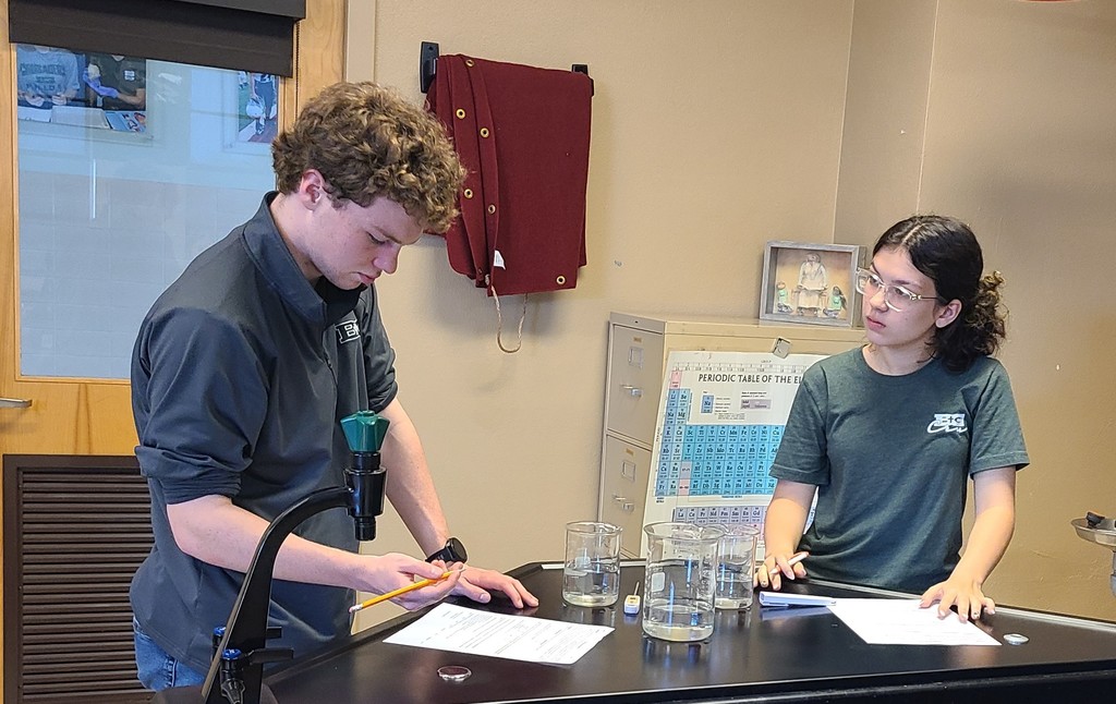 Students noting the results on their paper.