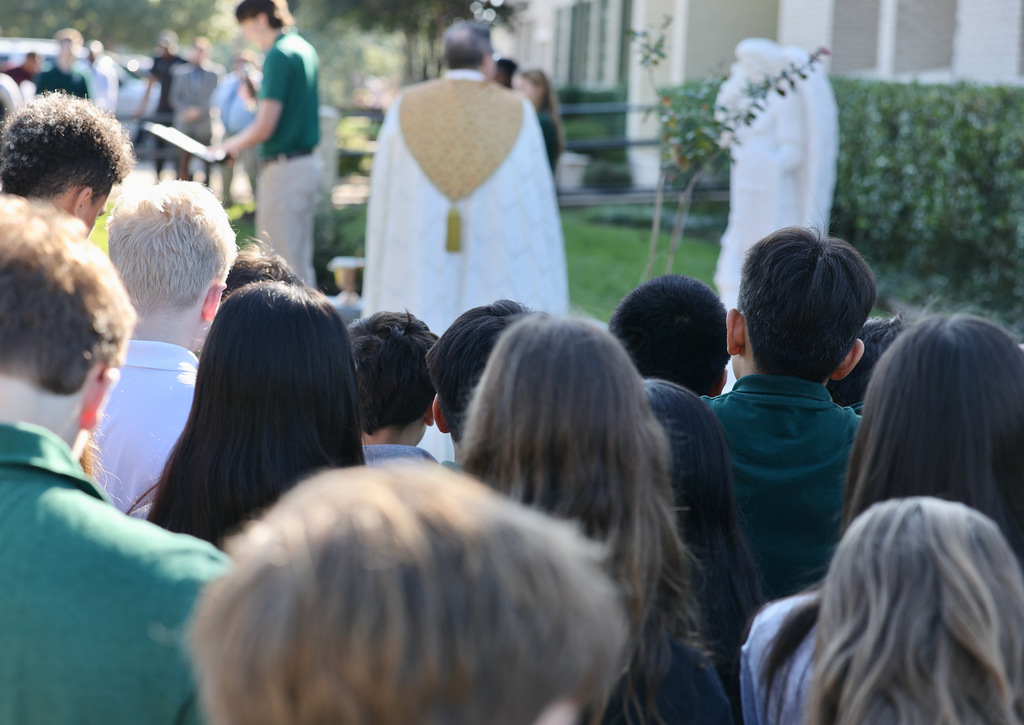 Students watching the blessing of the St. Michael the Archangel statue.