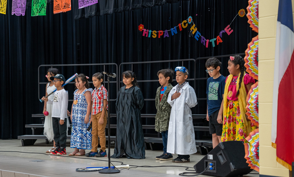 elementary age students on stage singing