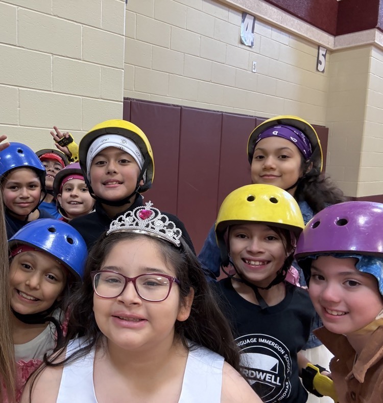 students in helmets and crowns