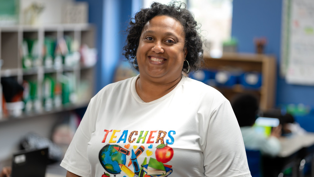 African American woman smiling big in her classroom