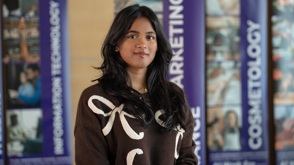 teen girl with long dark hair wearing brown sweater with white bows on it