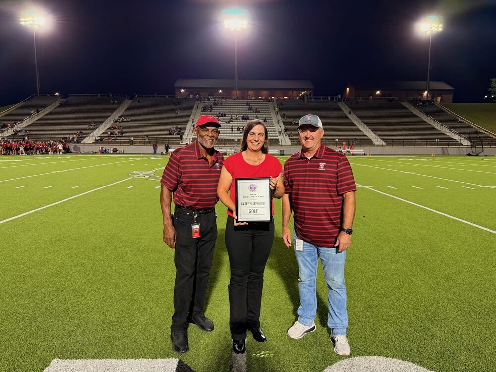 Katelyn Sepmoree holding certificate with Tyler Legacy officials