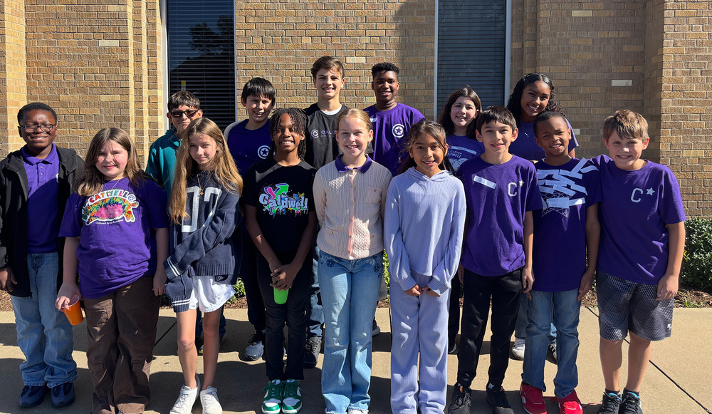 elementary and middle school age boys and girls standing outside school