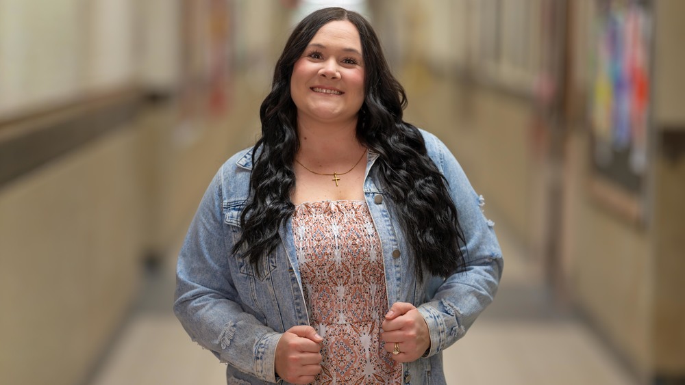 woman with long dark hair wearing a denim jacket
