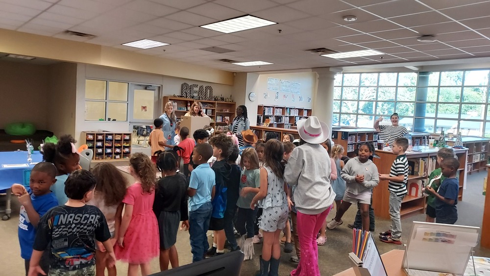 First graders learn about voting in the library.