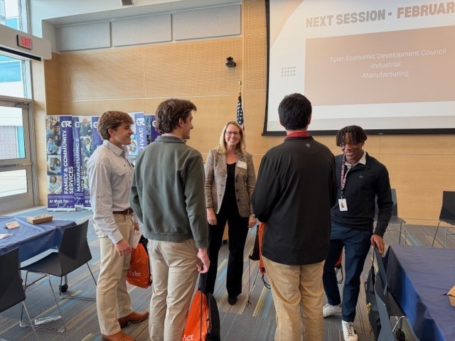 woman talks to group of teenboys