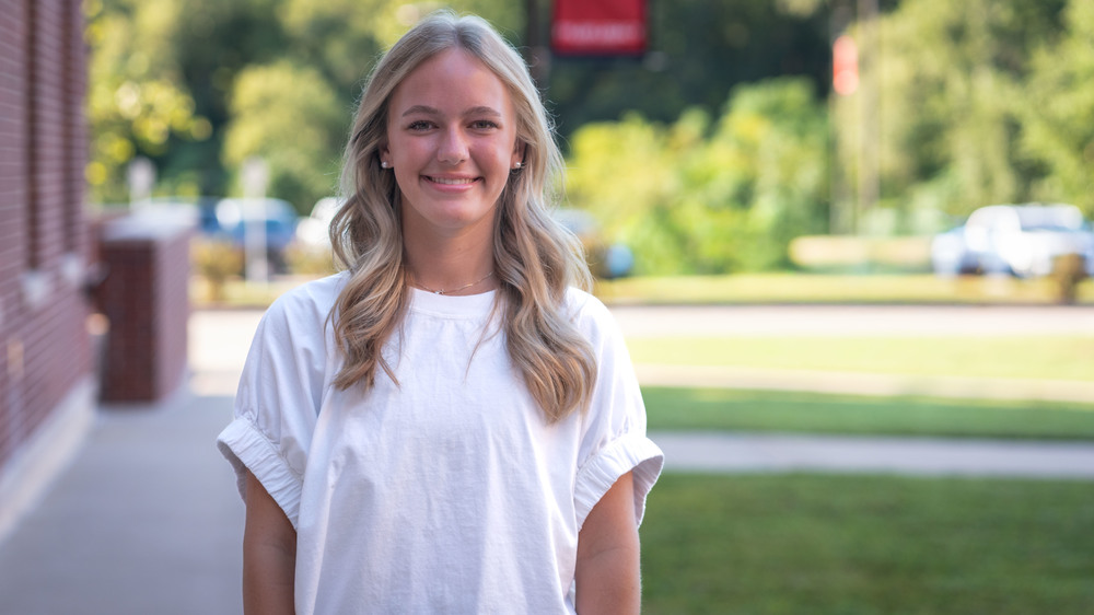 teen girl with long blonde hair wearing a white blouse