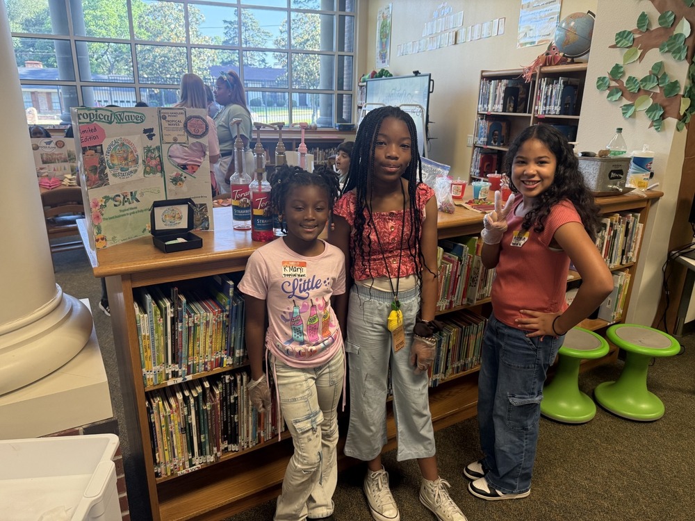 students standing with their business and merchandise