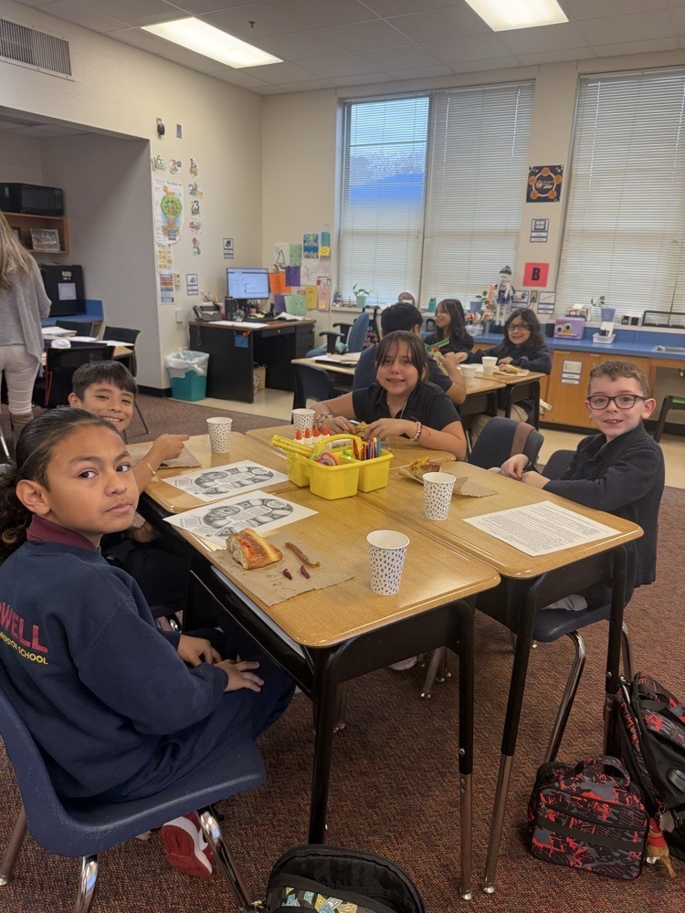 students at desk eating