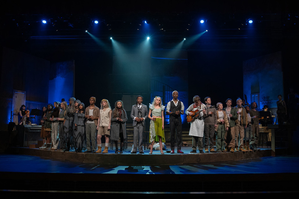 high school students in costumes on stage