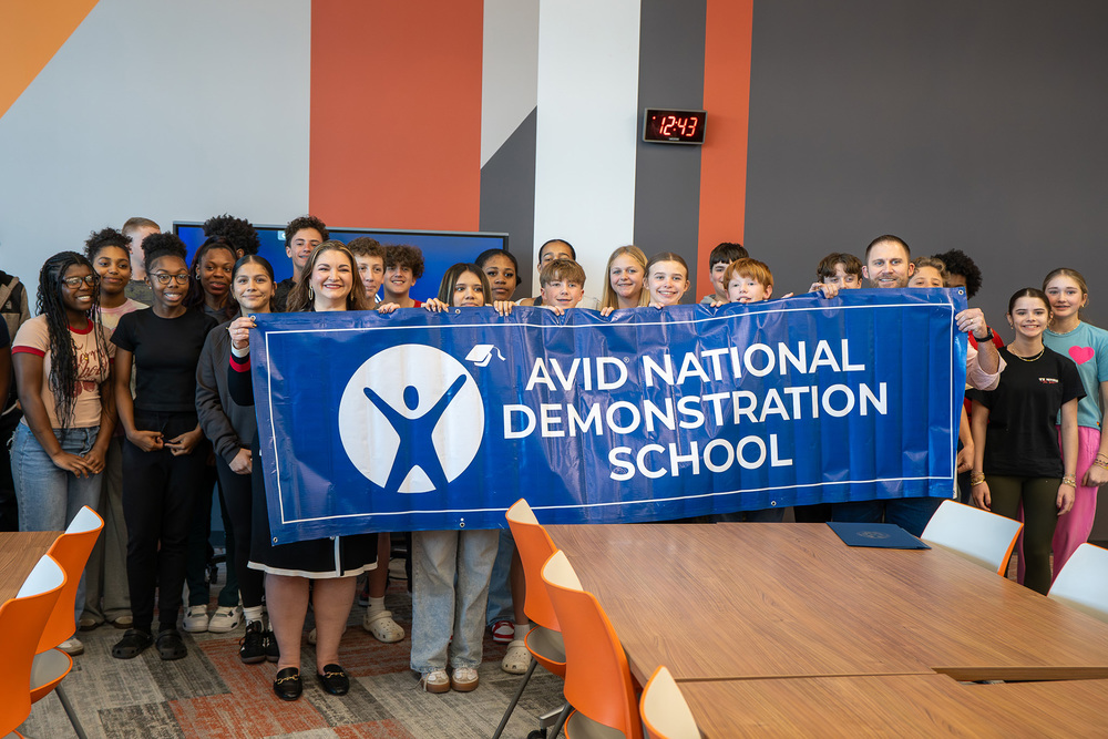 middle school kids holding AVID National Demonstration School banner