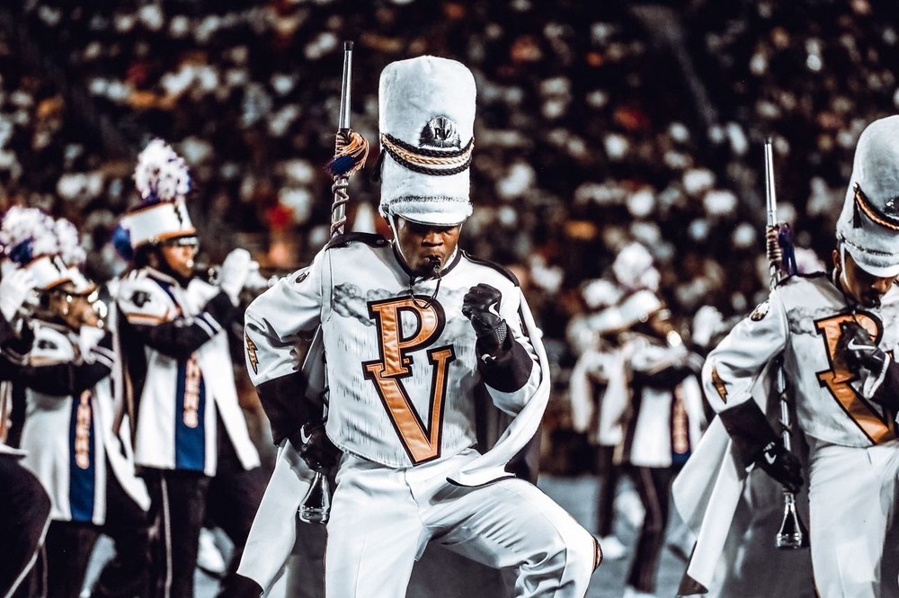 marching band in white uniforms