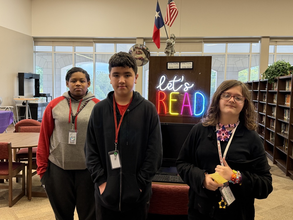 Top 3 AR readers are photographed in library