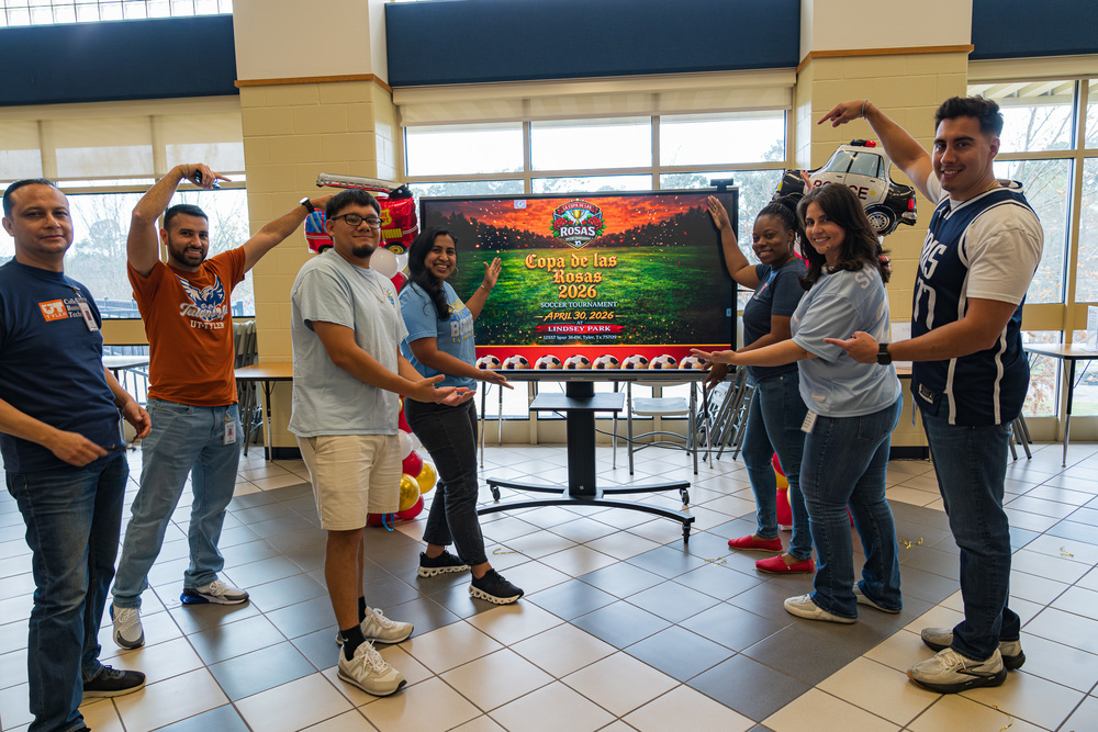 men and women pointing at tv screen
