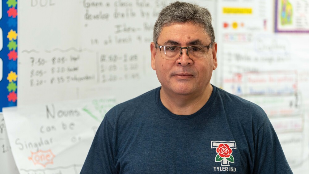Man standing in classroom in front of whiteboard