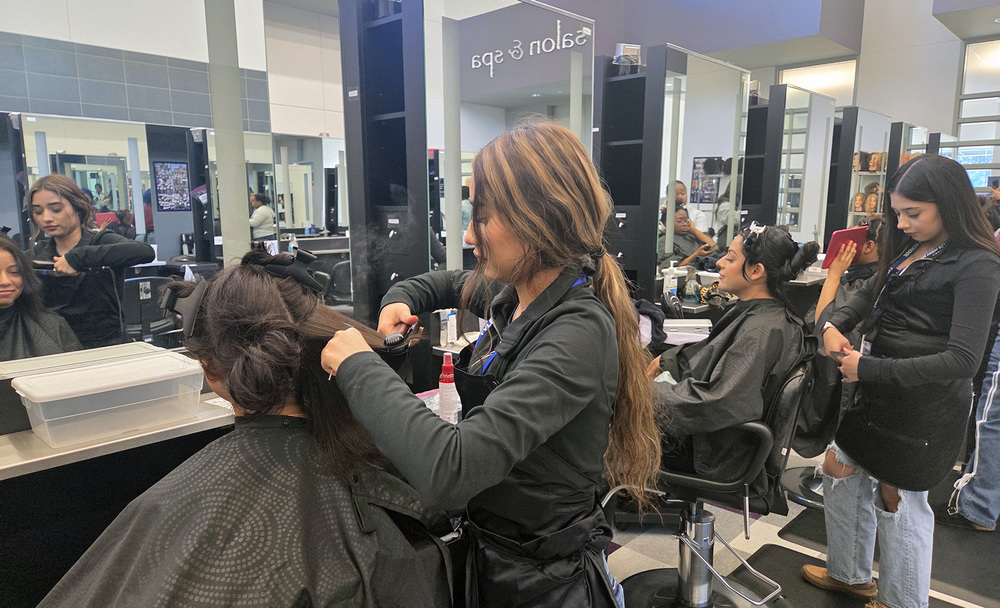 teen girls cutting women's hair in salon