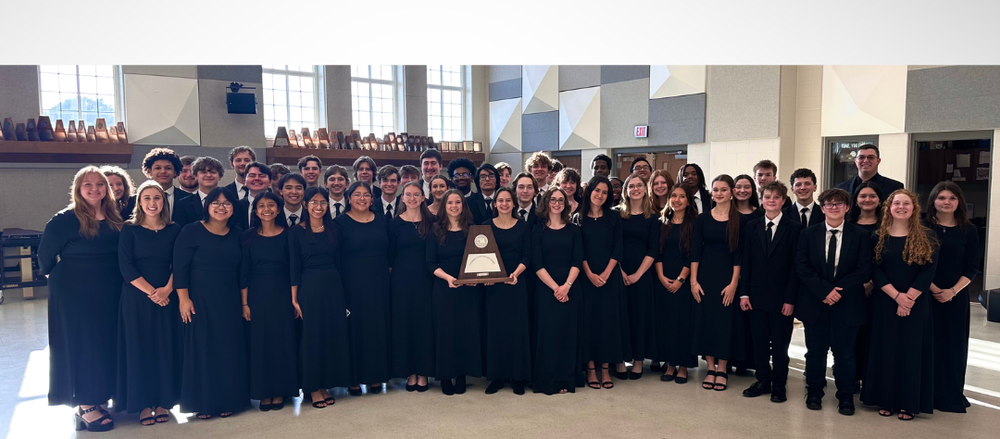 teen boys and girls in choir outfits holding award