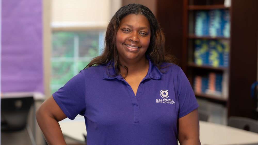 woman standing in classroom with hand on hip